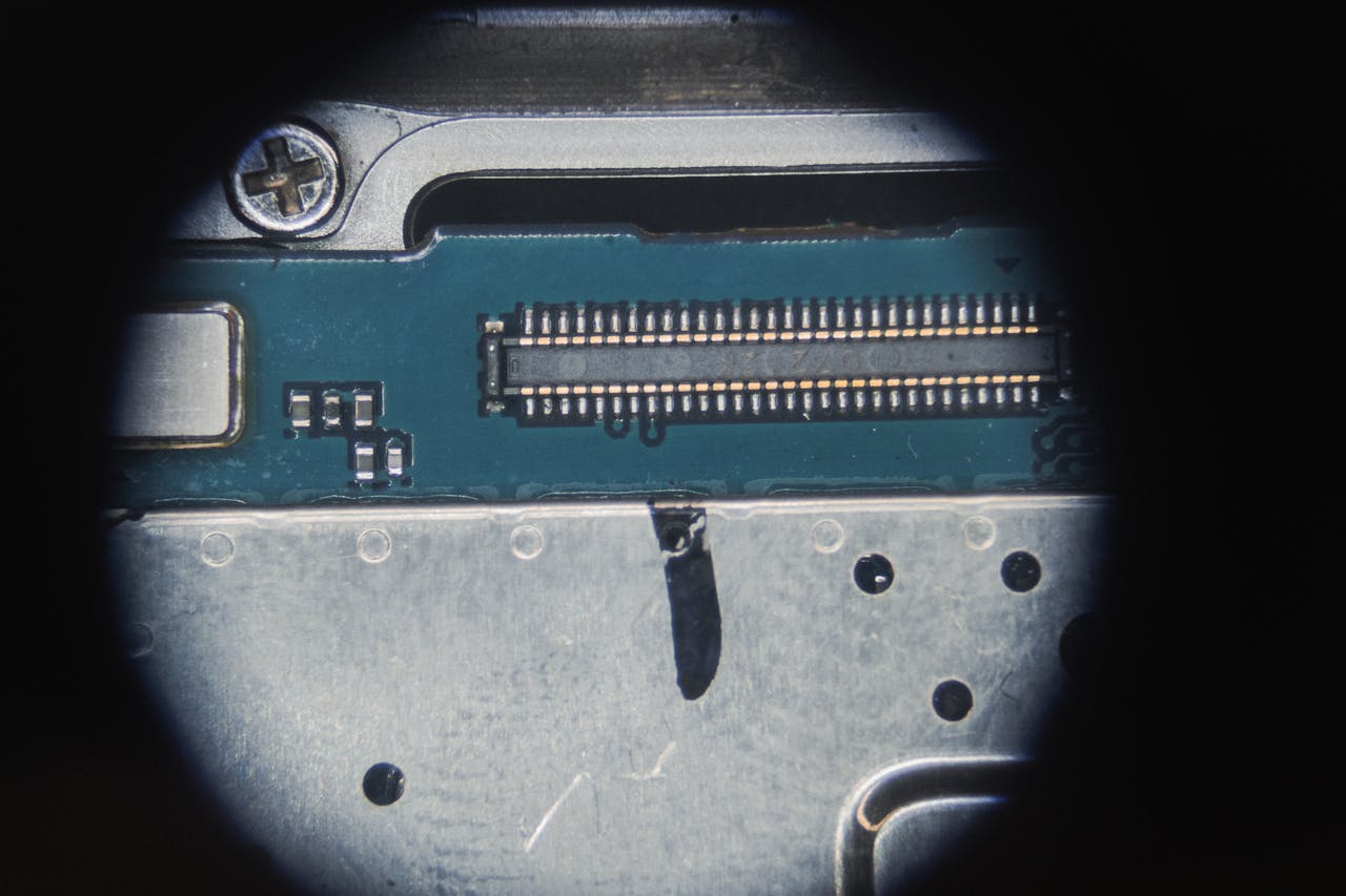 contact-img Detailed macro of an electronic circuit board showing micro components and connections.